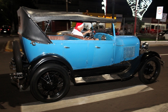 Desfile de carros antigos com papais noéis encanta noite de sexta